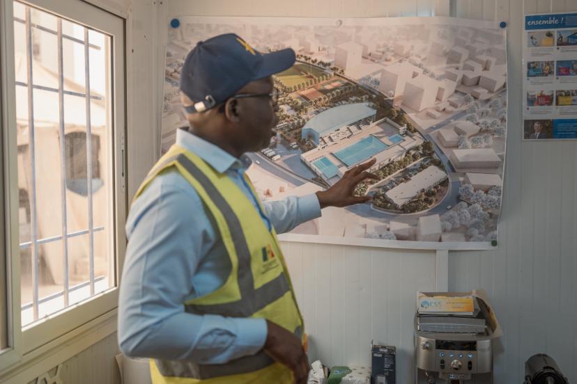 Babacar Senghor, coordinator of the Dakar 2026 Youth Olympic Games project, reviewing pool construction plans
