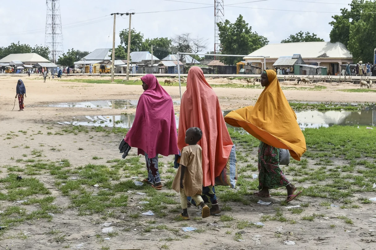 Survivors and relatives of victims of a suspected Boko Haram attack walk in Babban Gide on September 4, 2024. At least 81 people were killed and several reported missing following an assault by suspected Boko Haram jihadists in Yobe State, northeastern Nigeria, local officials confirmed on September 3, 2024. About 150 suspected Boko Haram terrorists, armed with rifles and rocket launchers, stormed the Mafa neighborhood on more than 50 motorcycles around 4 p.m. on Sunday, stated Abdulkarim Dungus, Yobe State police spokesman.