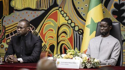 Senegalese Prime Minister Ousmane Sonko (left) and President Bassirou Diomaye Faye (right) attend a ceremony at the presidential palace in Dakar, October 16, 2025.