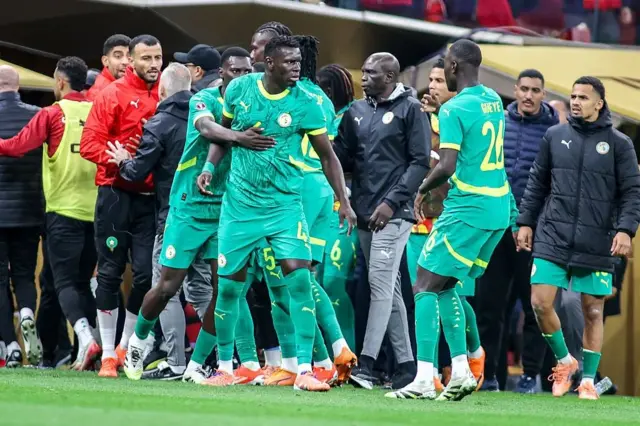 The Senegal team angry with referee Jean-Jacques Ndala for awarding a late penalty after consulting the VAR during the Africa Cup of Nations final match between Senegal and Morocco at Prince Moulay Abdellah Stadium on January 18, 2026 in Rabat, Morocco.
