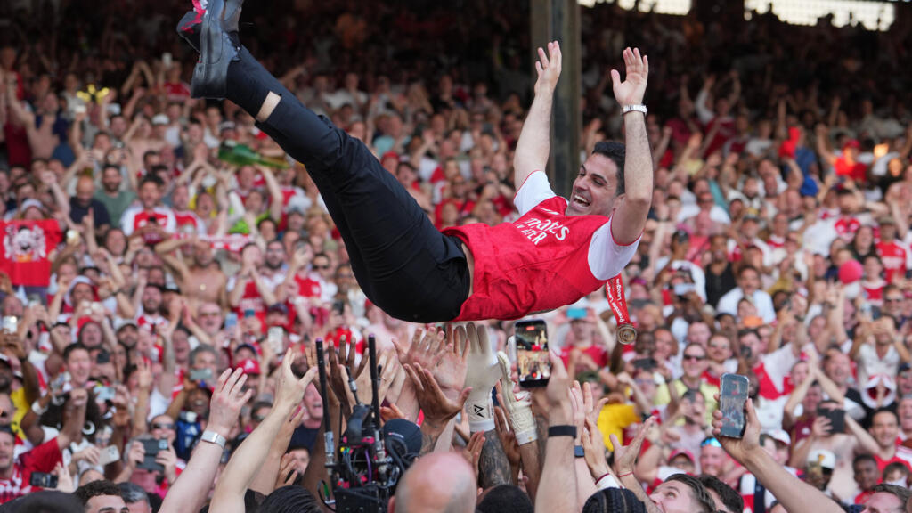 Arsenal manager Mikel Arteta is carried by players celebrating their Premier League title after the English football match between Crystal Palace and Arsenal in London, England, Sunday, May 24, 2026.