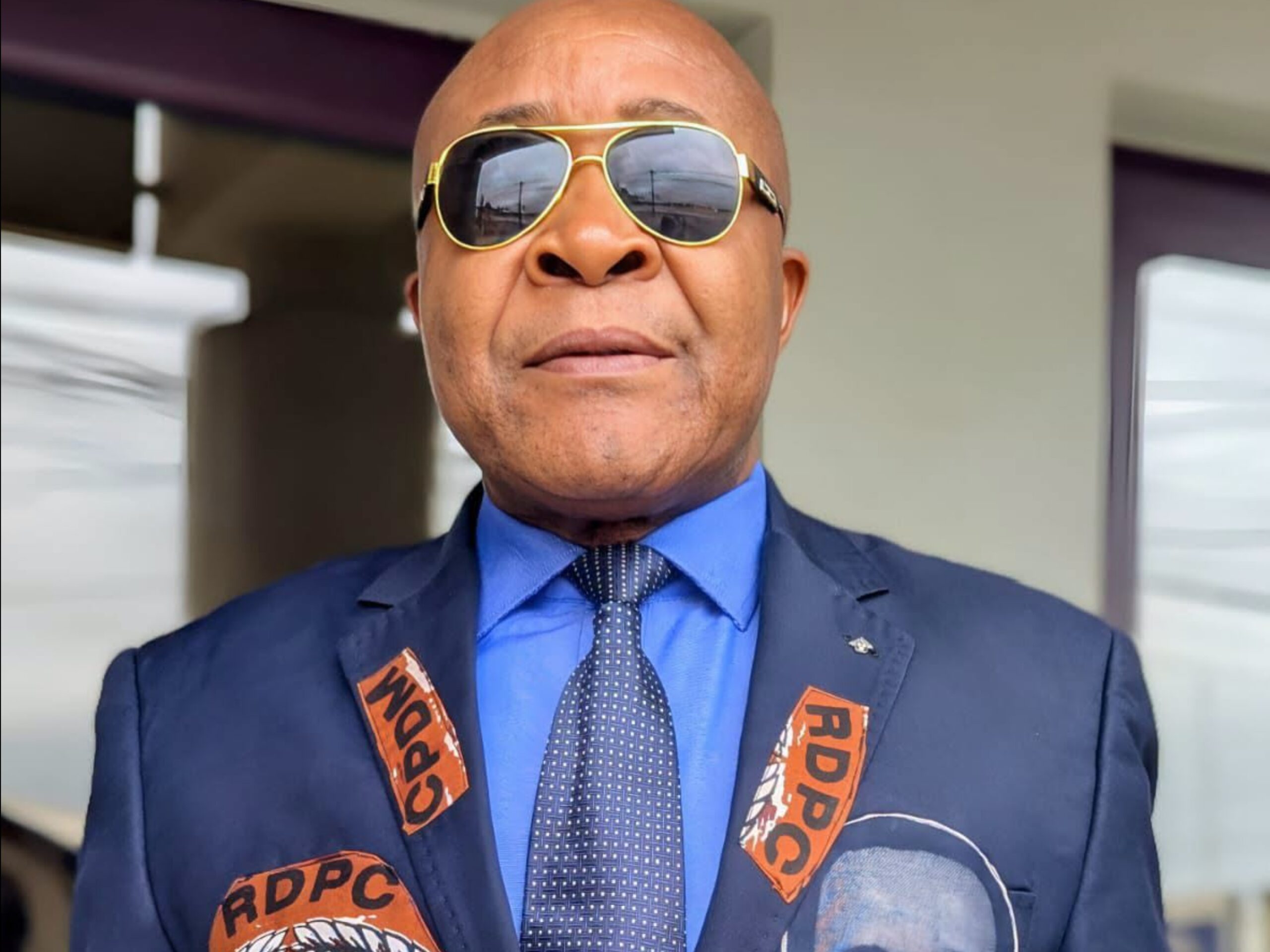 Cameroon professor Jean Gatsi says airport assault linked to his support for President Paul Biya