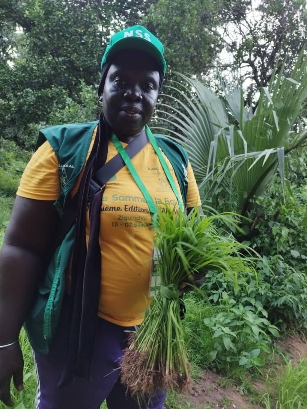 Mariama Sonko standing in her farm in Niaguis, a few kilometers from Ziguinchor in Casamance, tending to her agroecological crops.