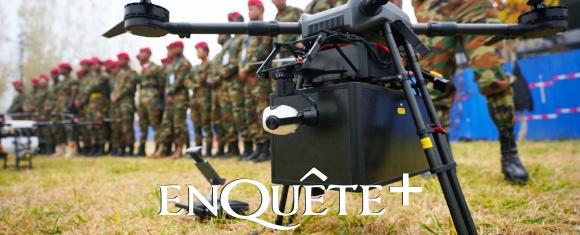Military drones in flight over an African landscape